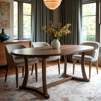 Dining room with wooden table and chairs, featuring a vase of flowers on the table.