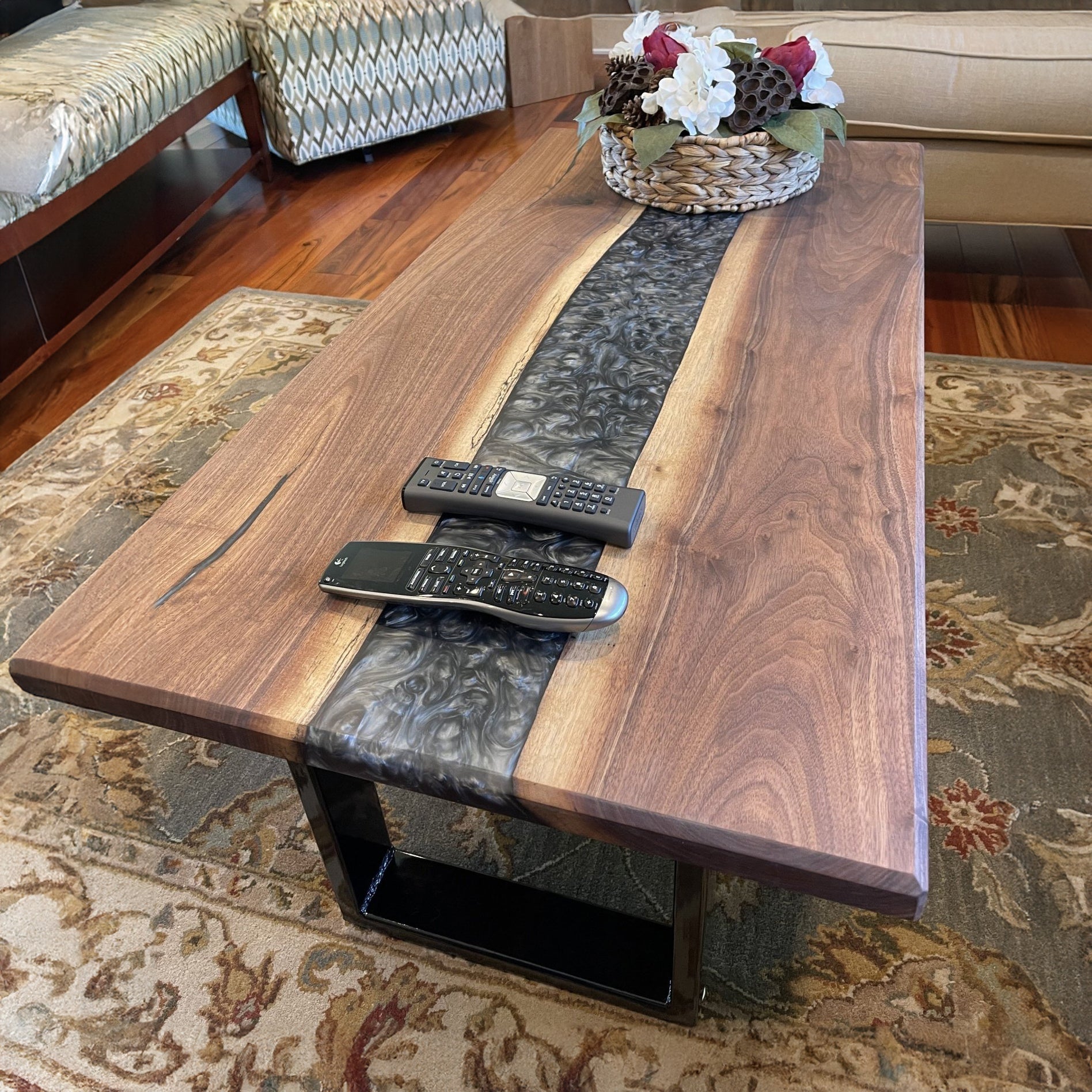 A walnut epoxy dining table with grey epoxy in a traditional living room setting