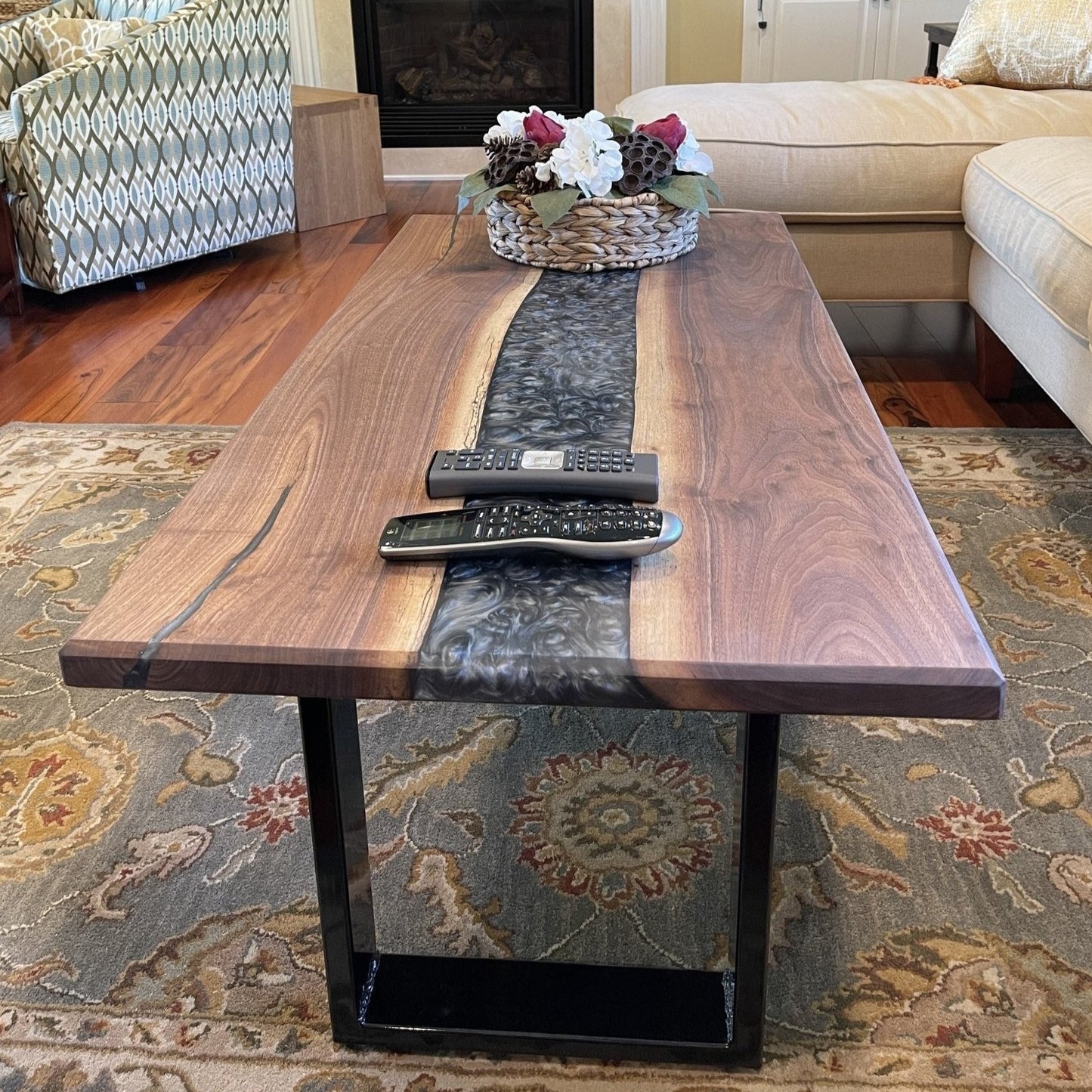 A walnut epoxy dining table with grey epoxy in a traditional living room setting