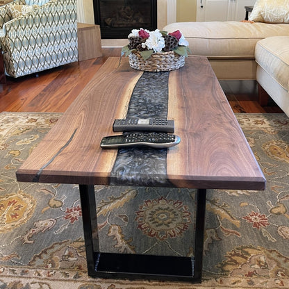 A walnut epoxy dining table with grey epoxy in a traditional living room setting