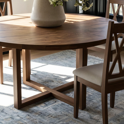 Dining room with wooden table and chairs, modern light fixture, and large plant on the table