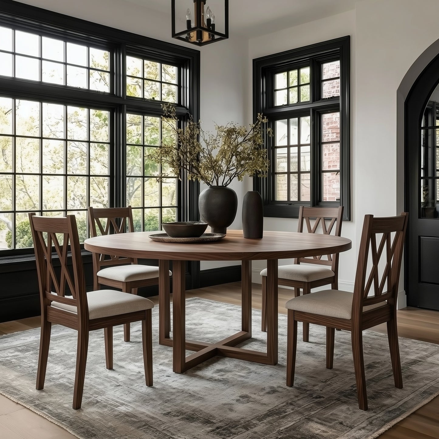 Dining room with wooden table and chairs, modern light fixture, and large plant on the table