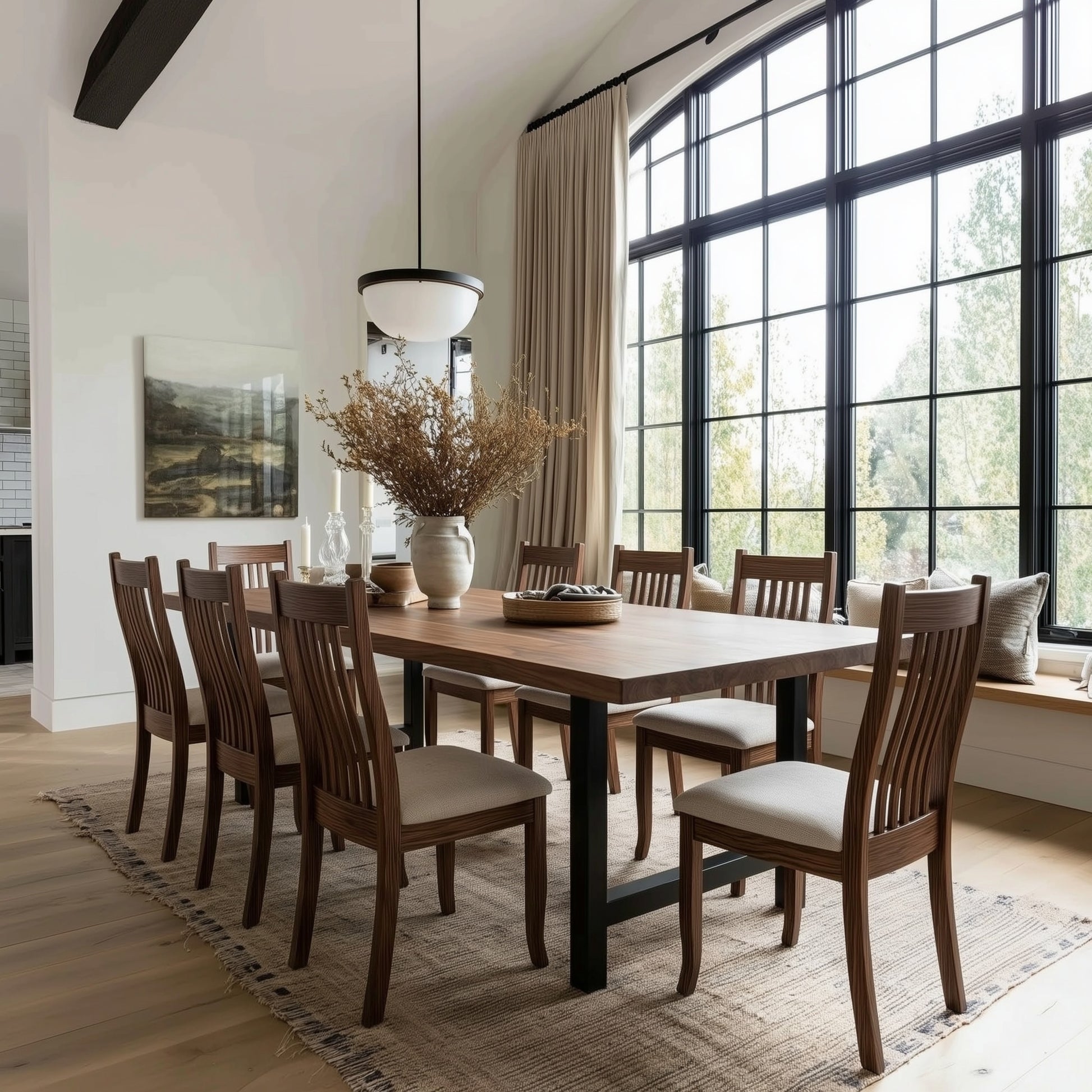 Dining room with wooden table and chairs near large windows