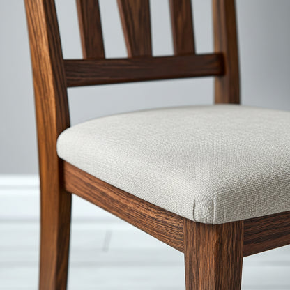 Wooden chair with a light gray cushion on a white background
