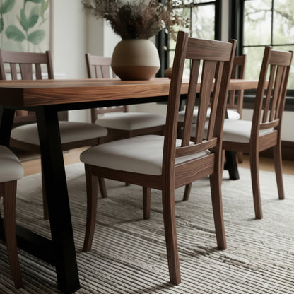 Dining room with wooden table and chairs on a striped rug