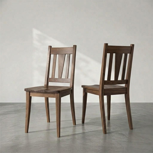 Two dark brown wooden dining chairs with slatted backs, shown from the front and back against a minimalist gray wall and concrete floor.