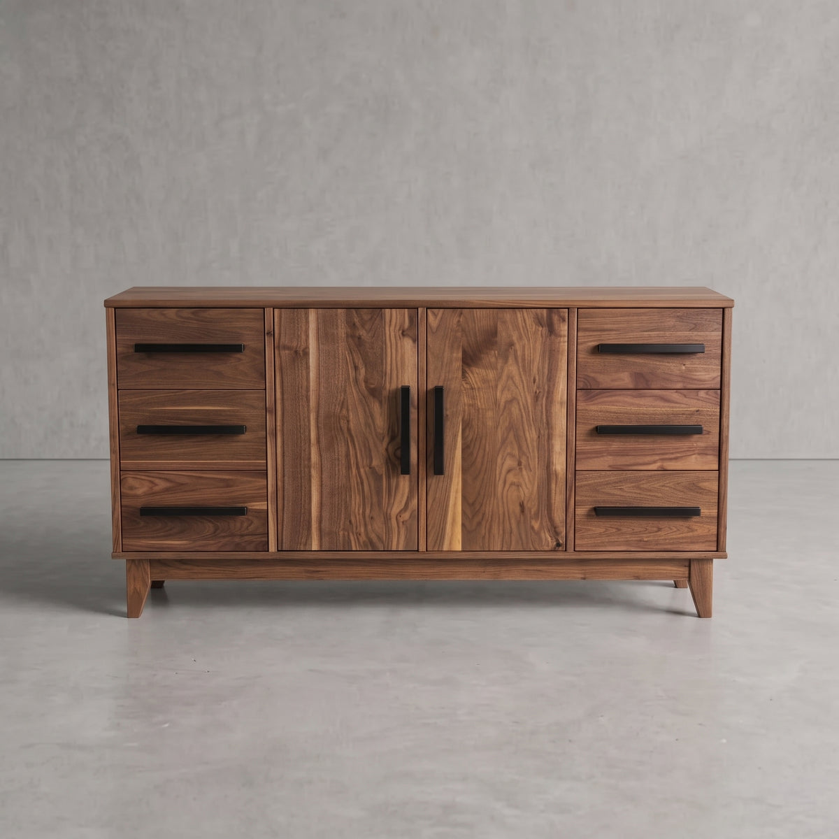 A mid-century modern wooden sideboard with a warm walnut finish, featuring two central doors with black vertical handles and four drawers on each side with black horizontal bar handles, set against a gray concrete wall and floor.