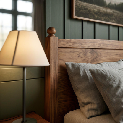 Wooden bed with lamp and pillows in a bedroom setting
