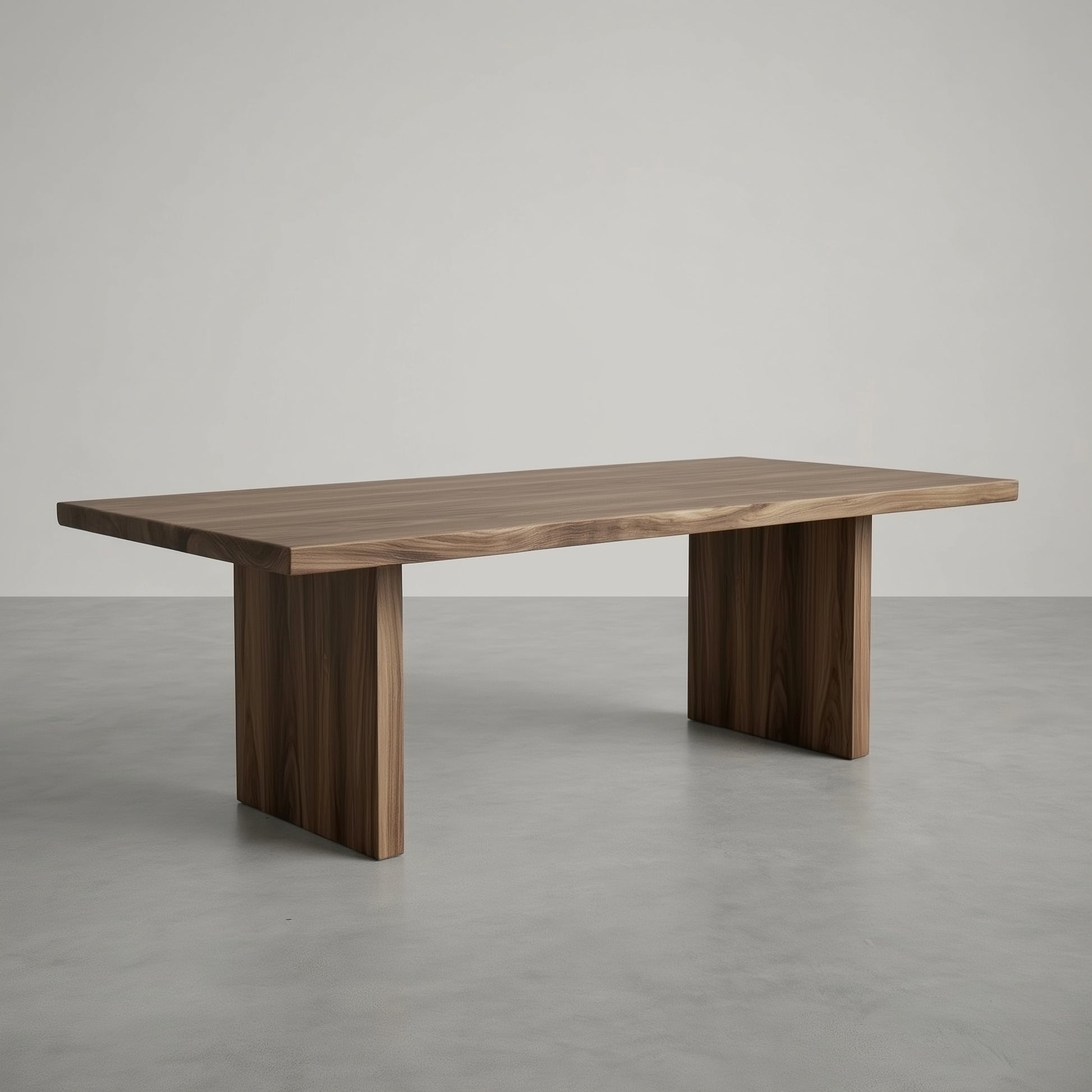 Wooden dining table on a gray floor with a neutral background