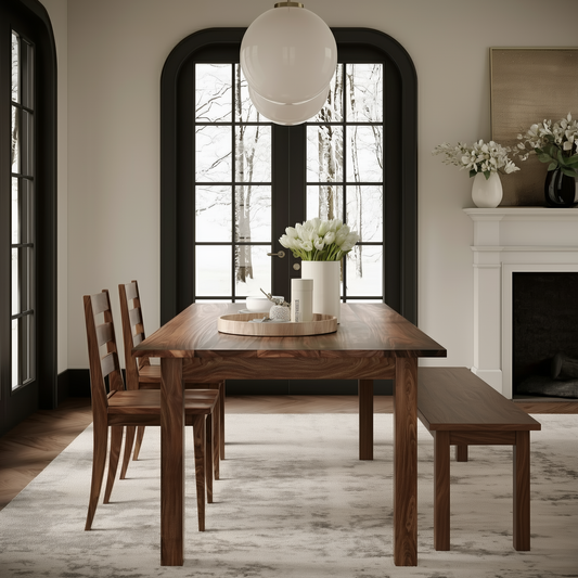 Walnut dining table with a matching bench and chairs in a upscale dining room with large windows