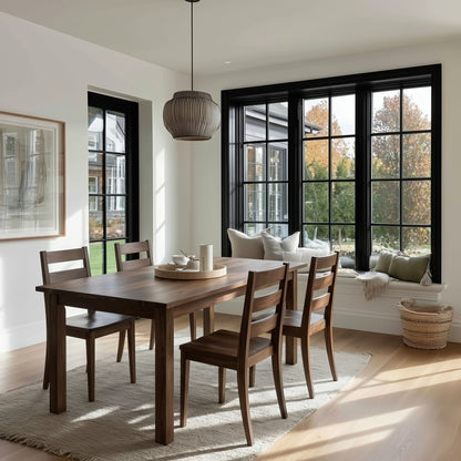 A rectangular dining table made of walnut wood with a straight edge, shown in an elegantly furnished dining room. The table is accompanied by matching wooden chairs, and the room features a large window, and a ceiling light.