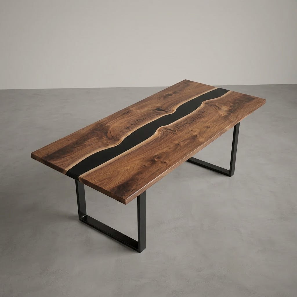 A rectangular wooden table with a live-edge design, featuring a dark brown wood grain top with a black resin inlay and black metal legs, shown on a gray concrete floor against a neutral gray wall.