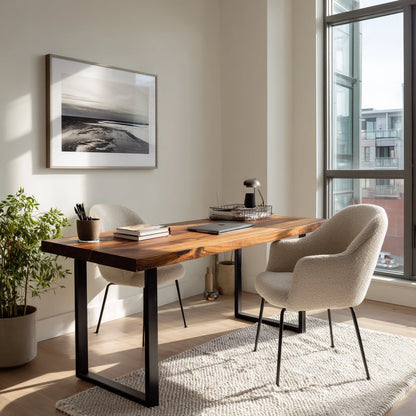 Modern home office with wooden desk, chairs, and framed artwork.