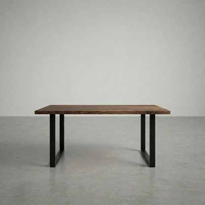wooden desk with black metal legs in a large empty room