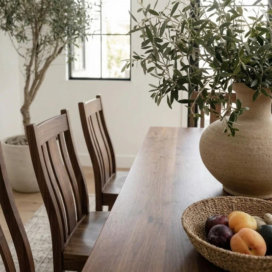 Dining room with wooden table, chairs, and decorative elements.