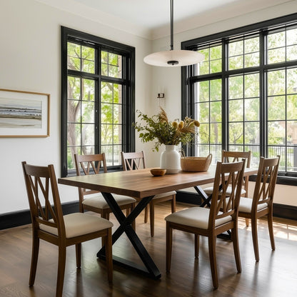 Dining room with wooden table and chairs near large windows