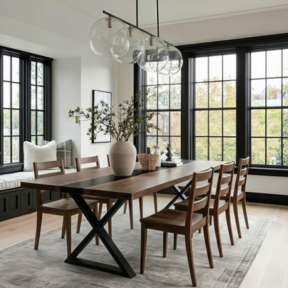 Dining room with wooden table and chairs, large windows, and modern pendant lights.