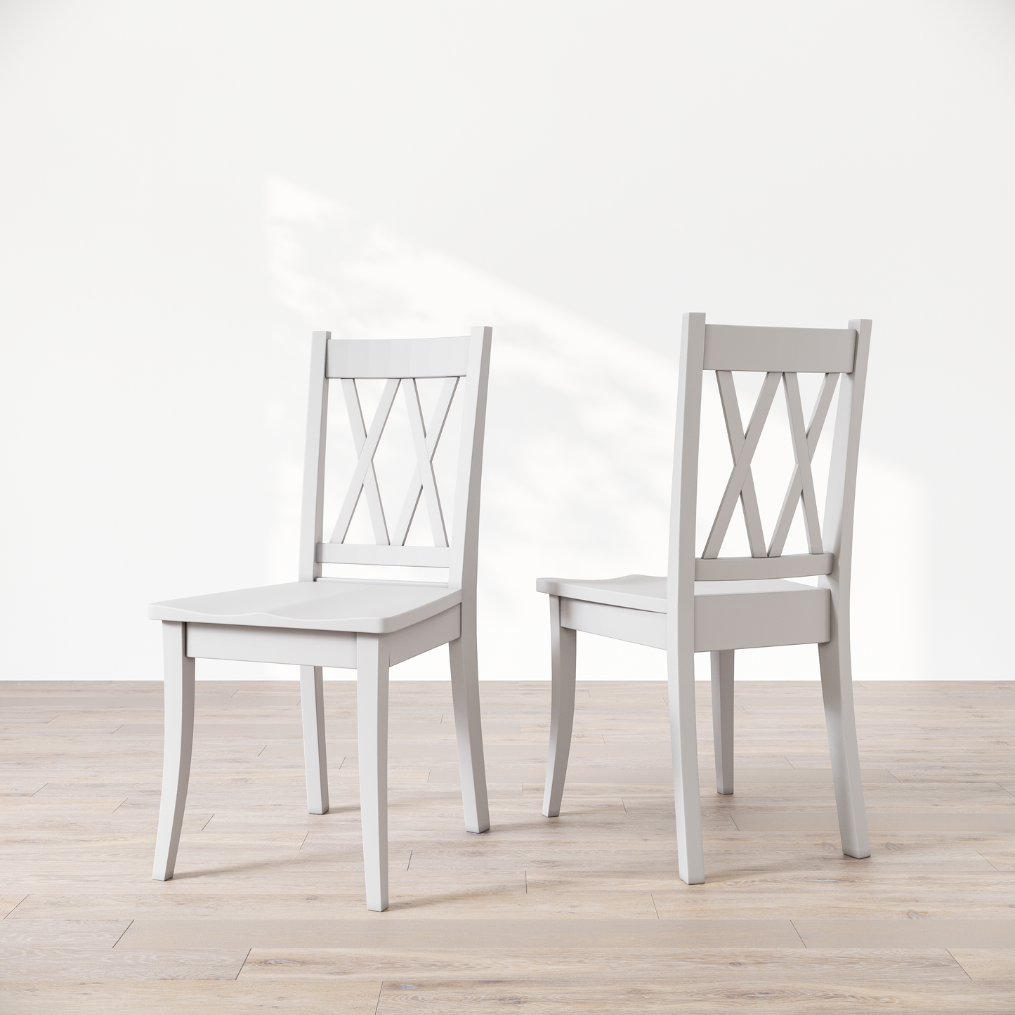Two white wooden dining chairs with a 'Double X Back' design, placed against a neutral background.