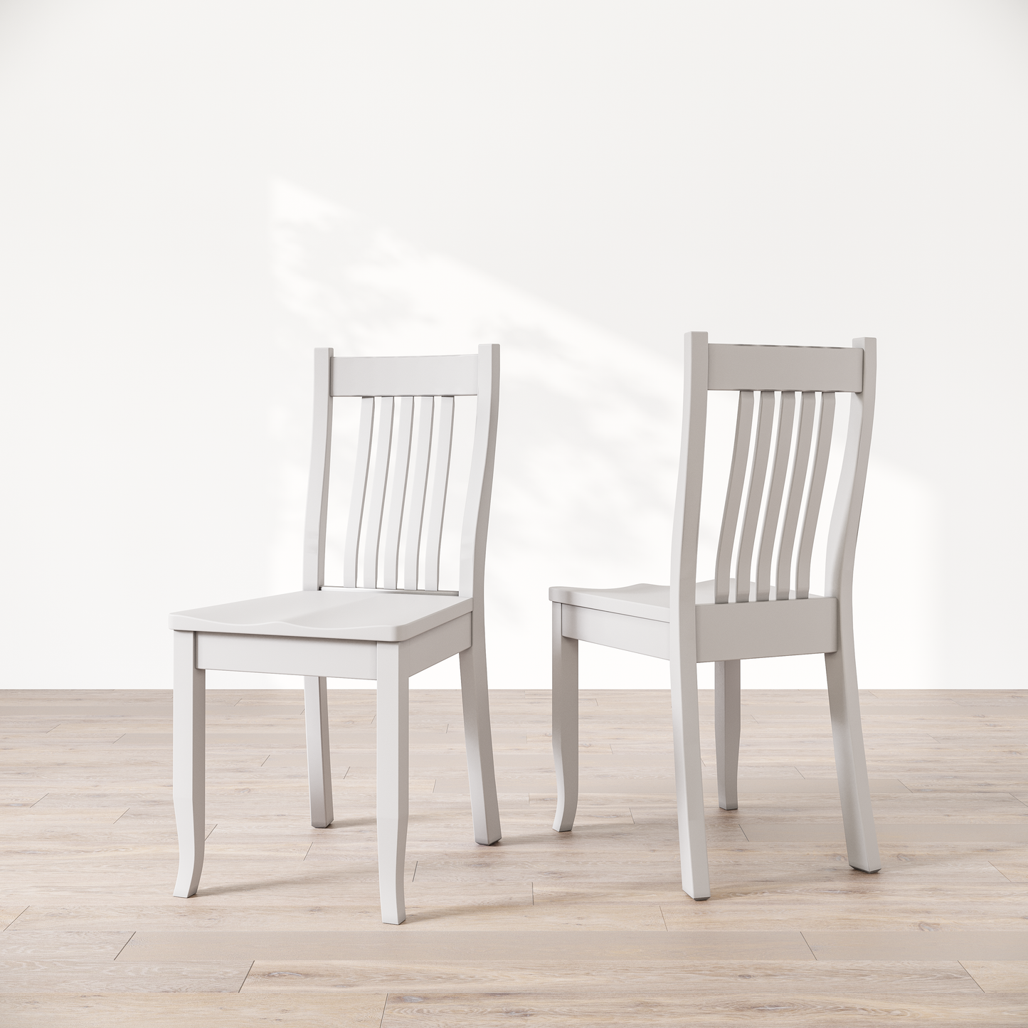 Two white wooden dining chairs, one facing forward and the other showing the side profile.