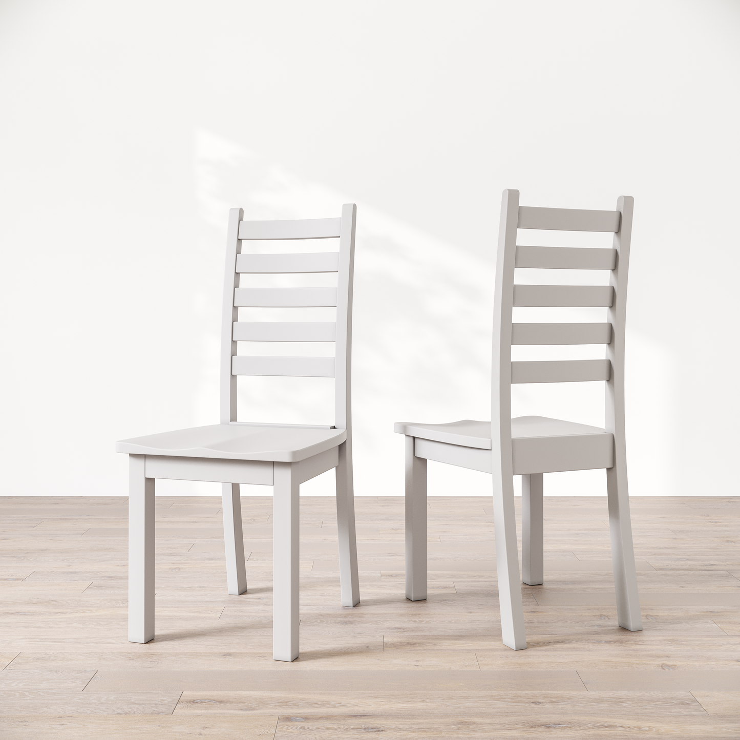 Two white wooden dining chairs with a commercial grade finish, displayed against a white background.