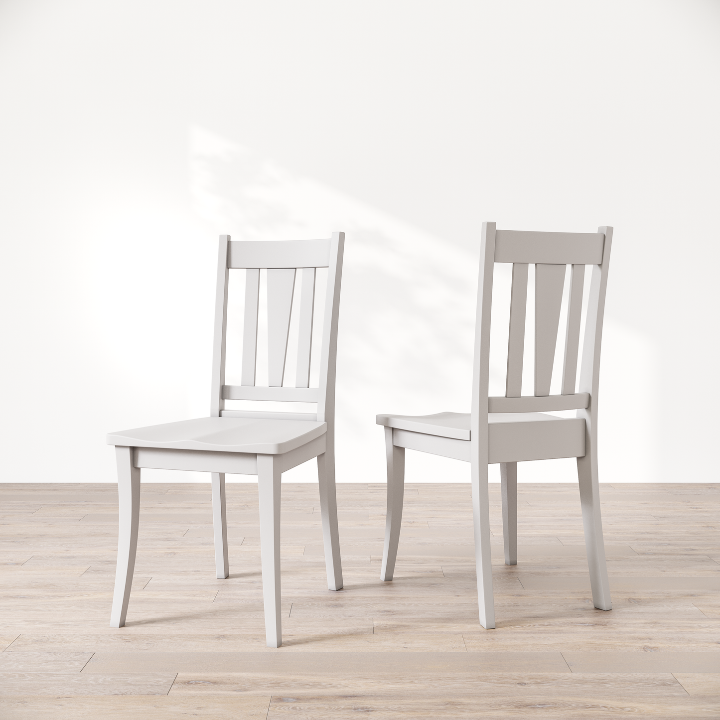 Two white wooden dining chairs with a brown finish, showcasing a slatted backrest and a solid seat, placed against a white background.