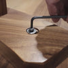 Video showing a close-up of a bolt being tightened into a table base
